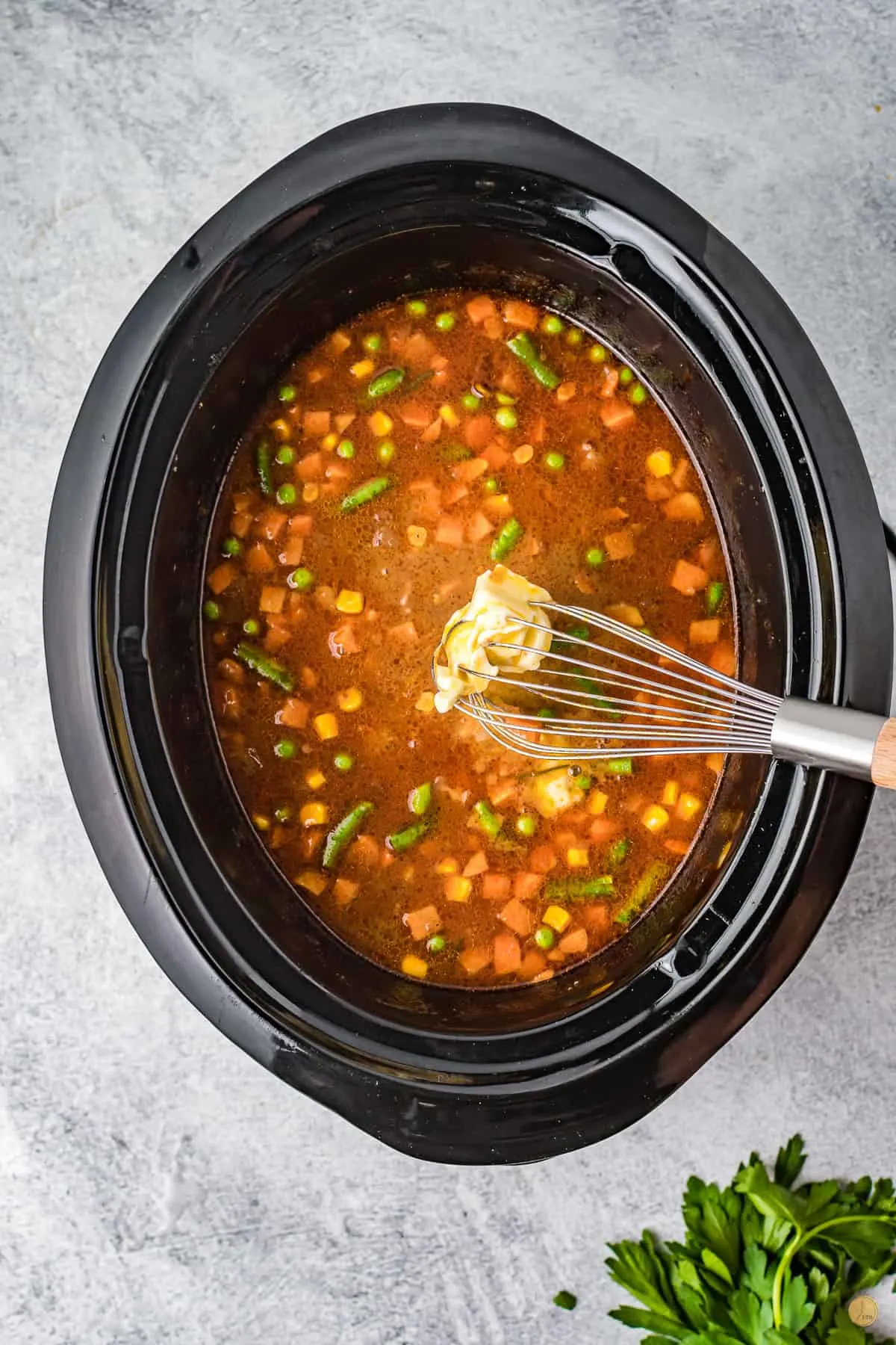 whisk and vegetables in a crock pot