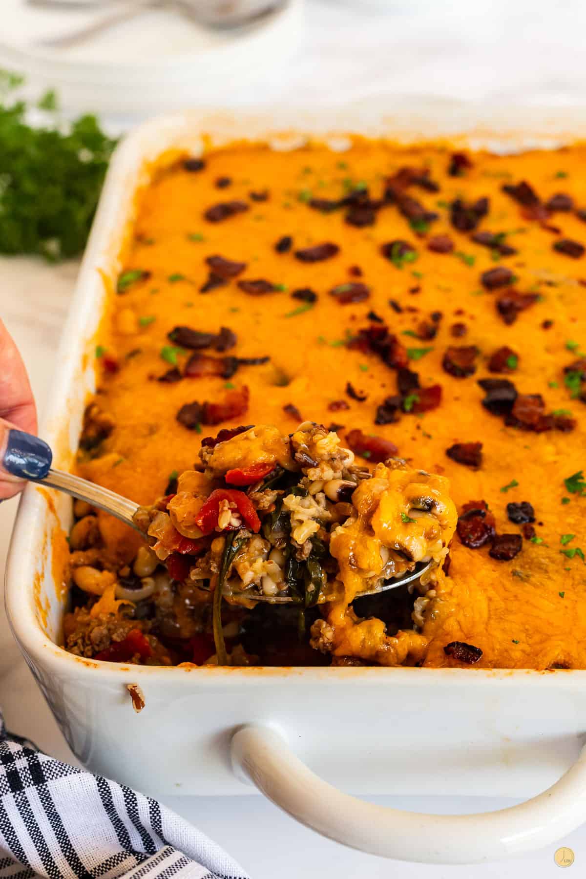 spoon scooping out some black eyed pea casserole