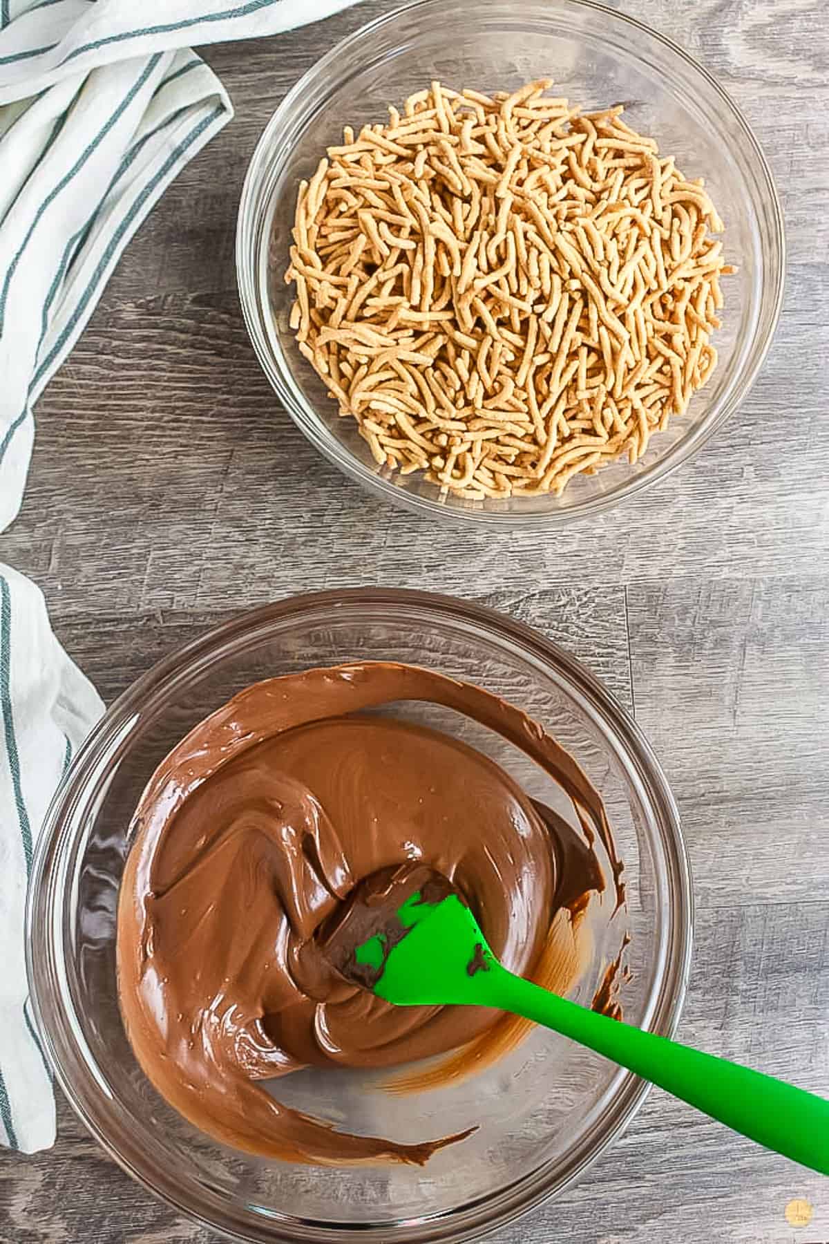 melted chocolate in a bowl with a green spatula