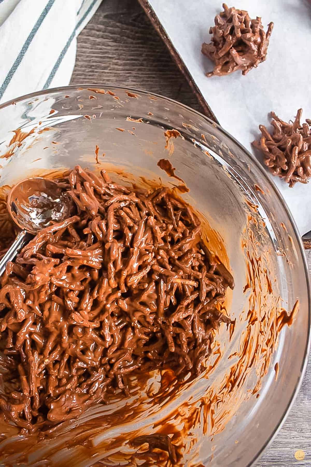 chocolate coated noodles being scooped into a bowl