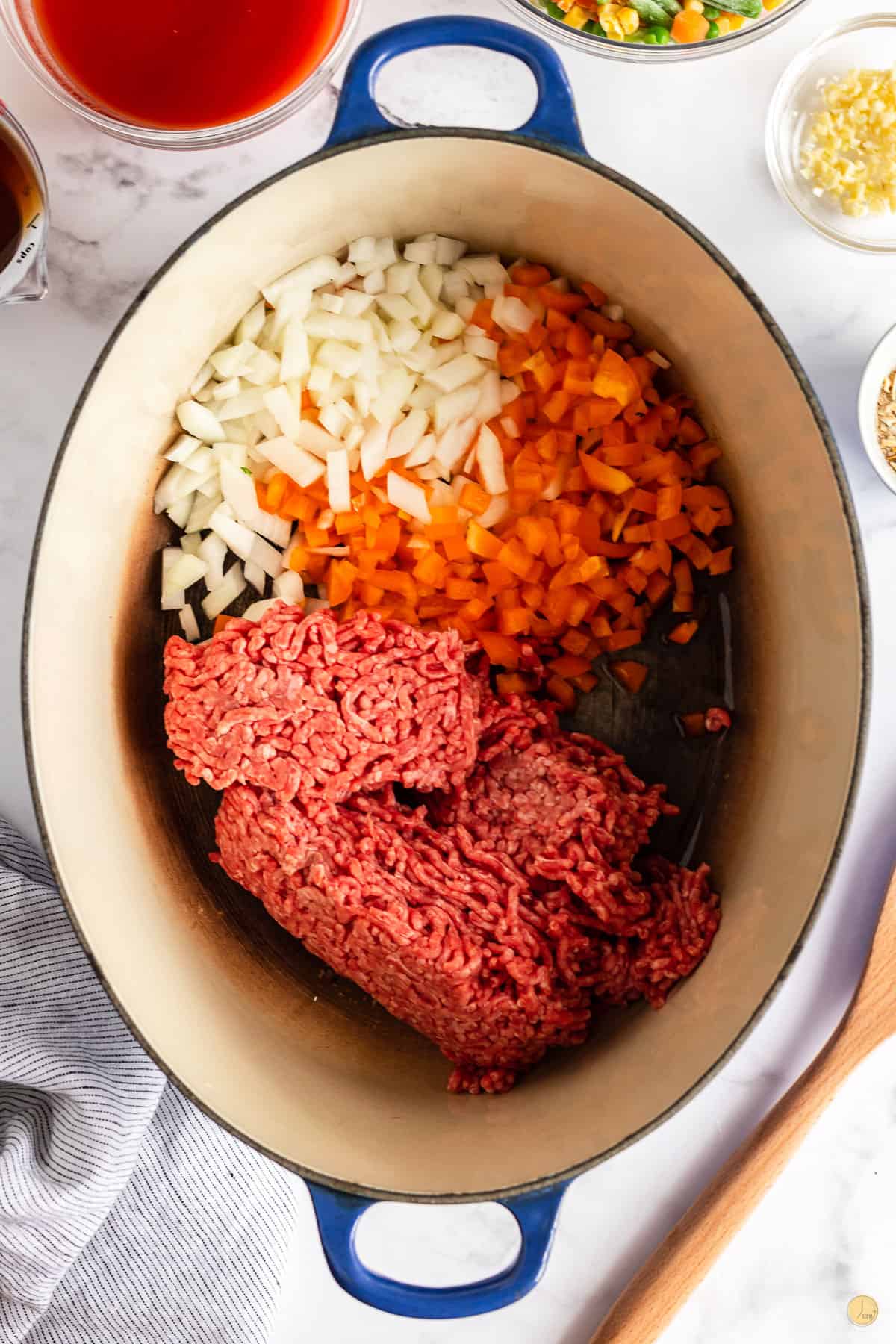 cooking beef and onions in a pot with minimal effort using a wooden spoon