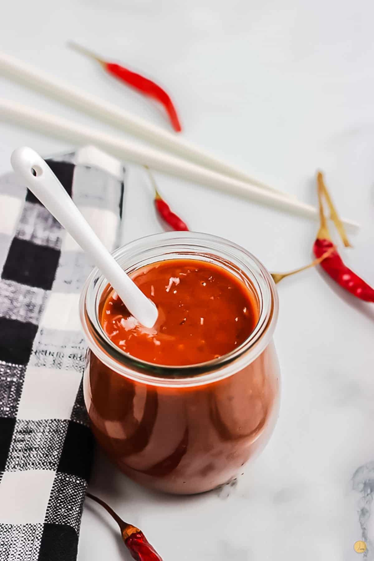 jar of sauce with spoon