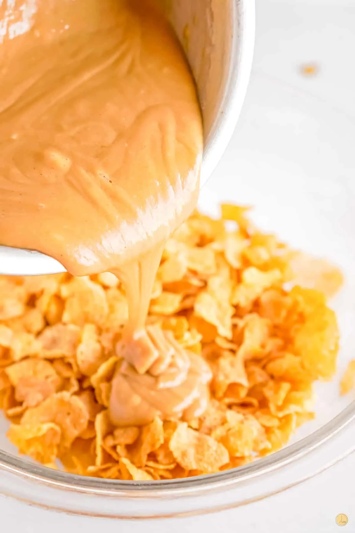 peanut butter pouring over corn flakes