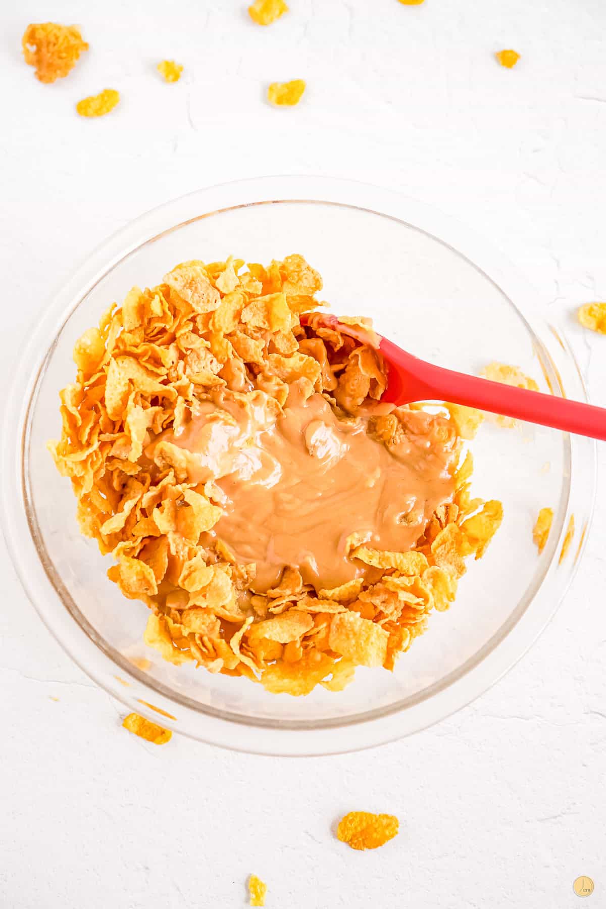 cornflakes in a bowl with red spatula