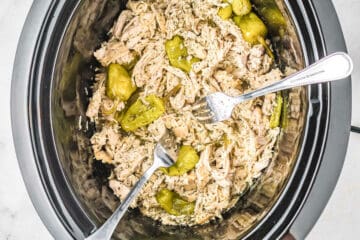 chicken in a crockpot with two forks