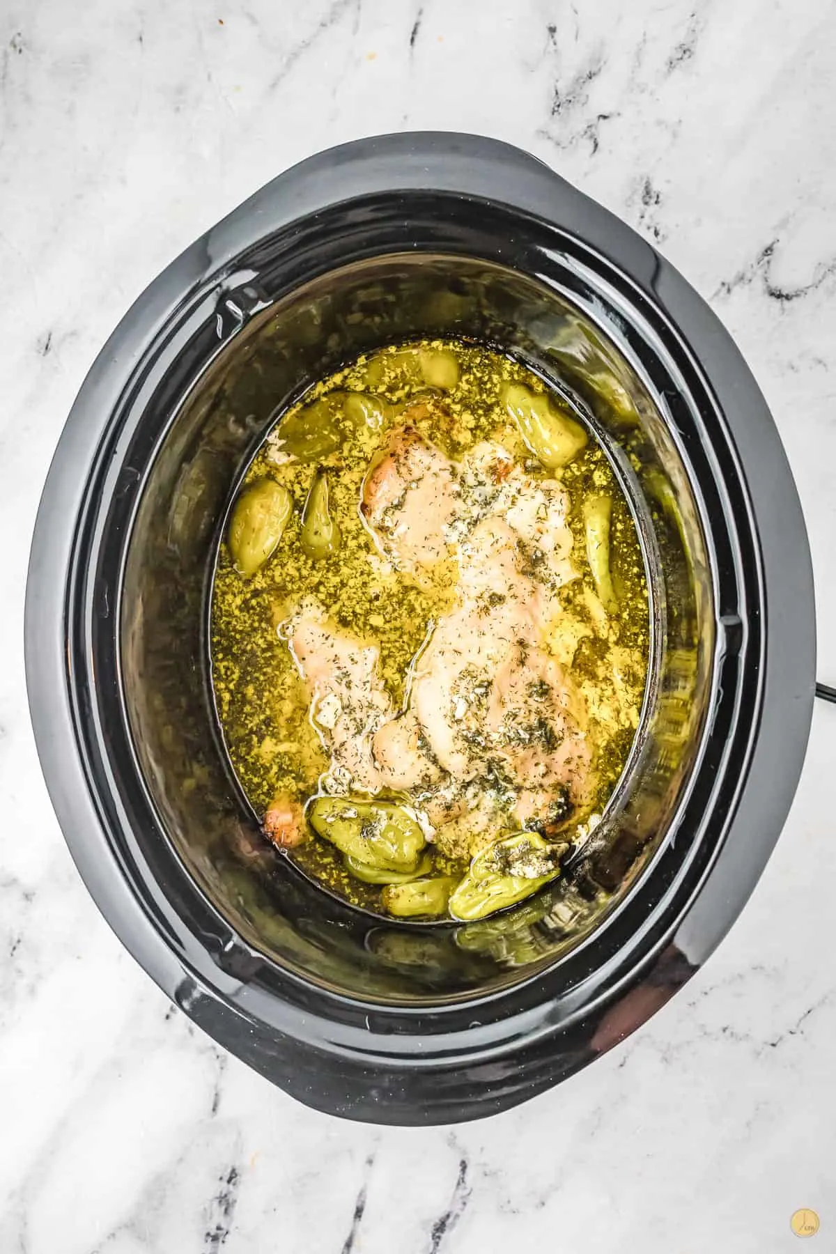 cooked chicken and butter in a slow cooker