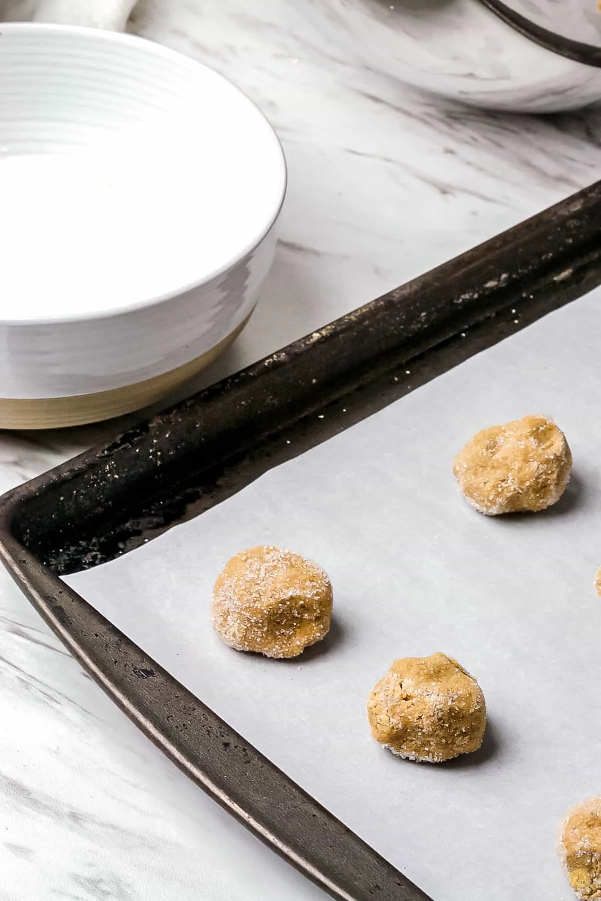 cookie balls on a baking sheet