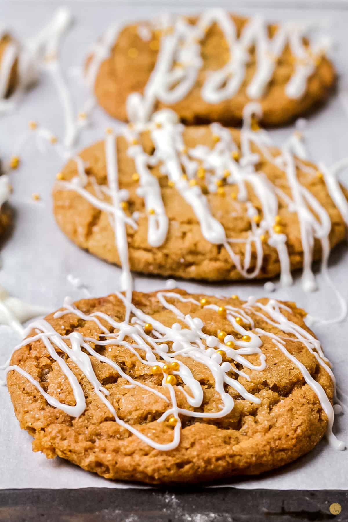 three cookies on a cookie sheet