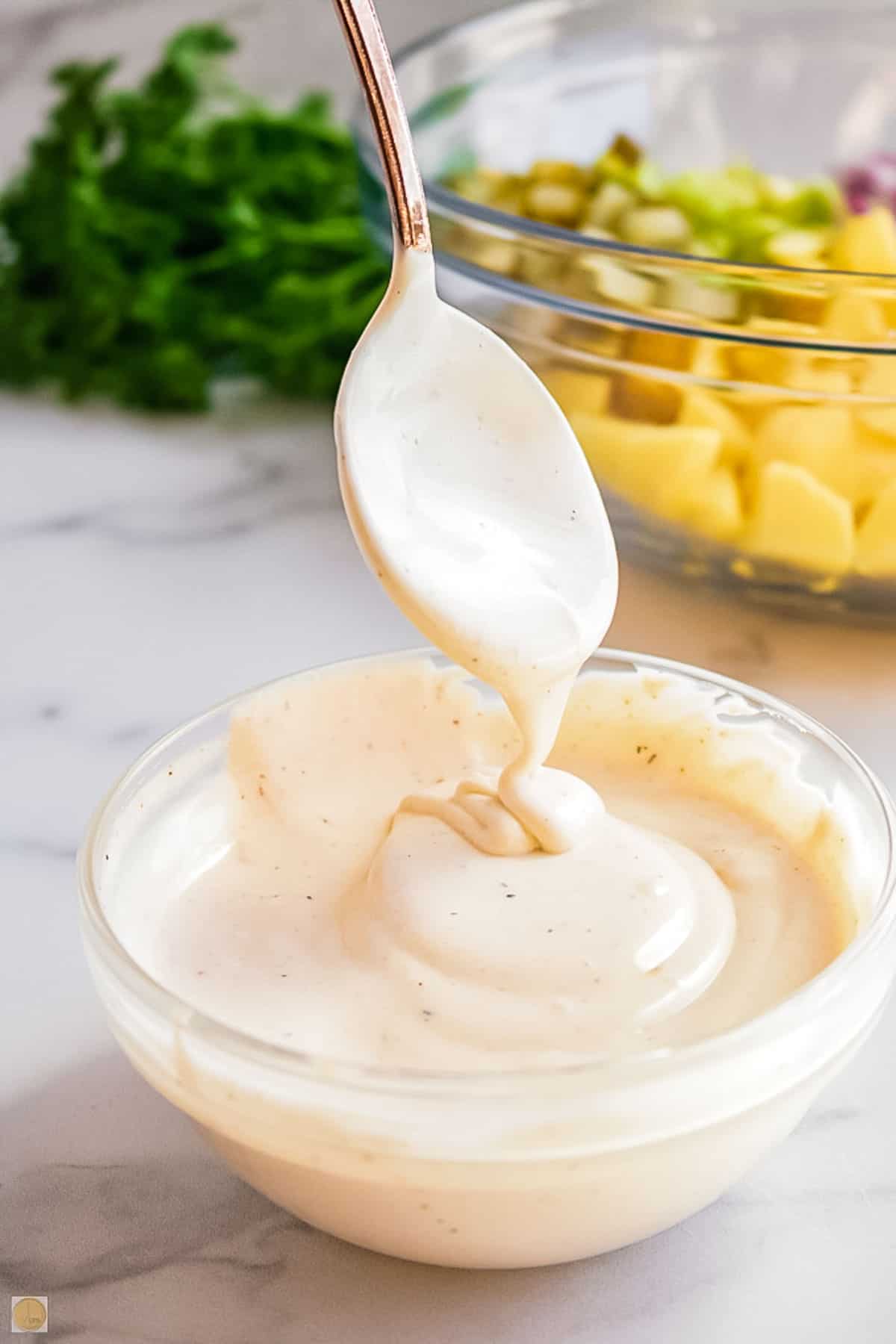 spoon drizzling dressing