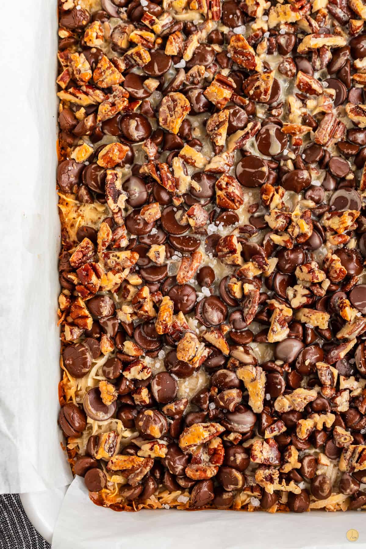 baked magic cookie bars in a white baking dish