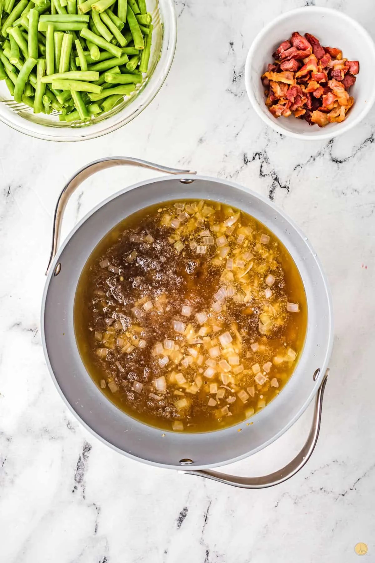 broth and onion in a pan