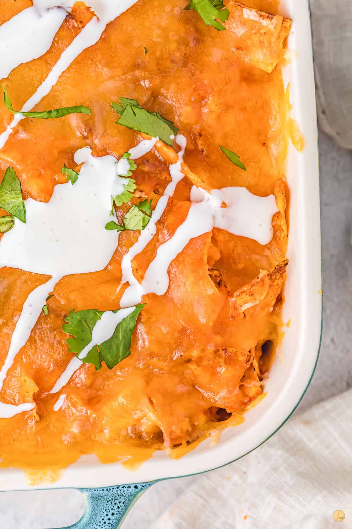 close up of doritos chicken casserole topped with sour cream