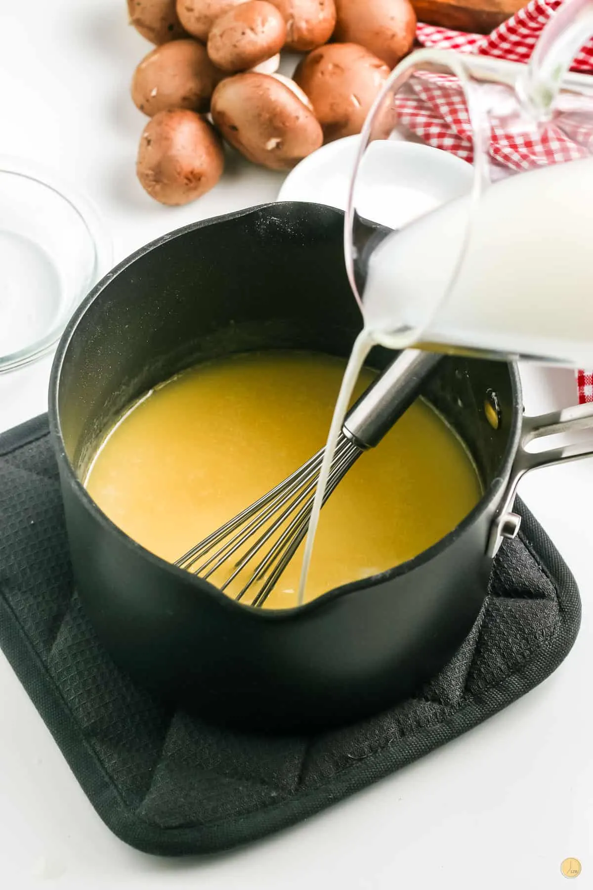 milk being added to pot