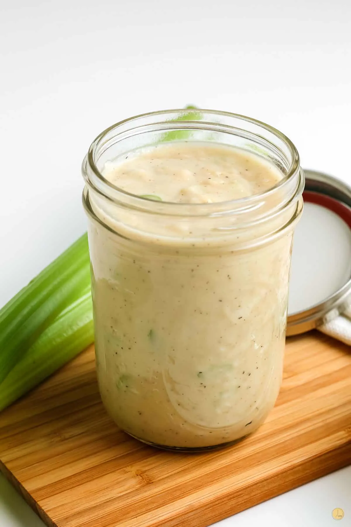 jar of celery soup with a cutting board