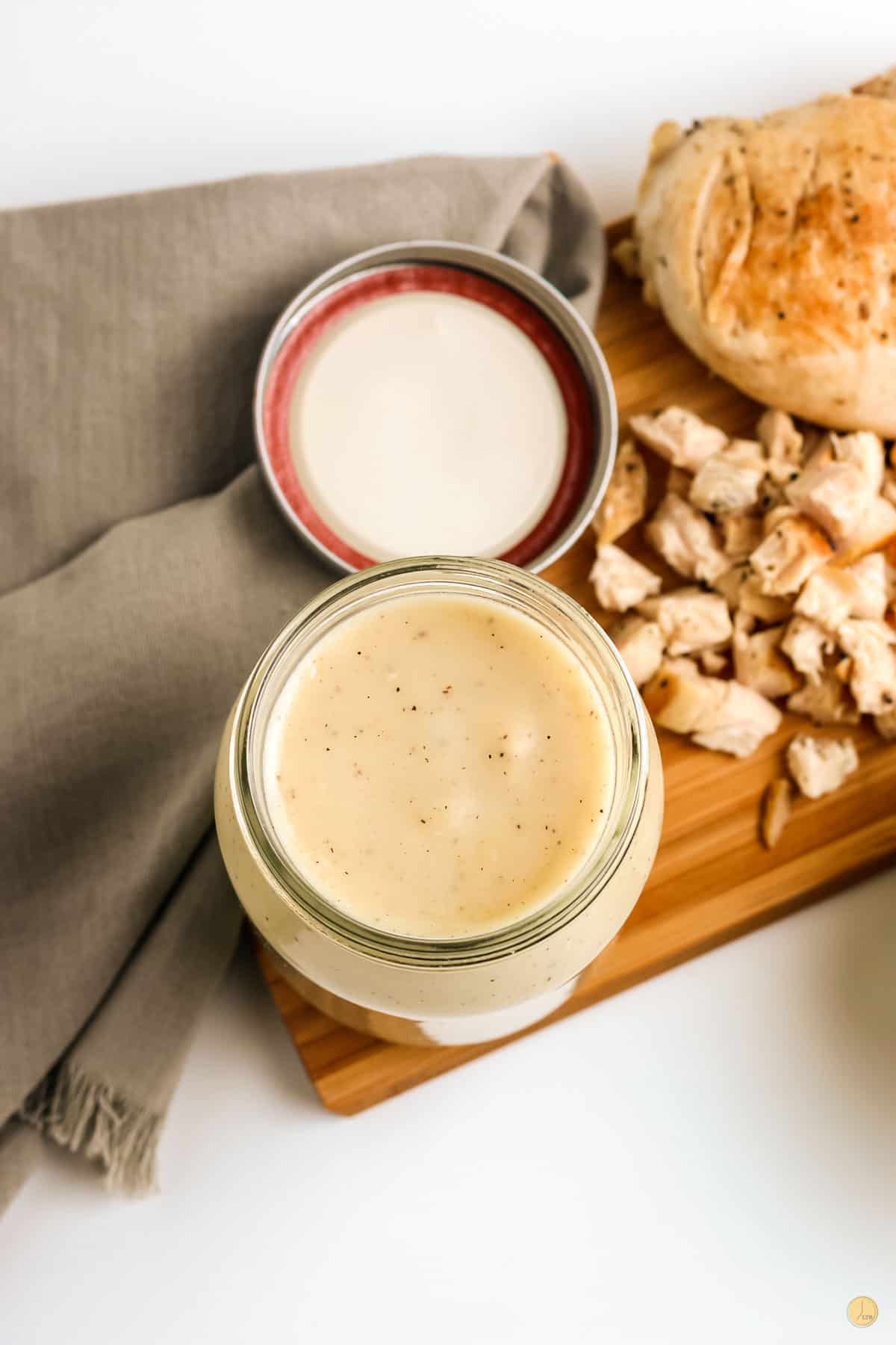 jar of chicken soup on a cutting board