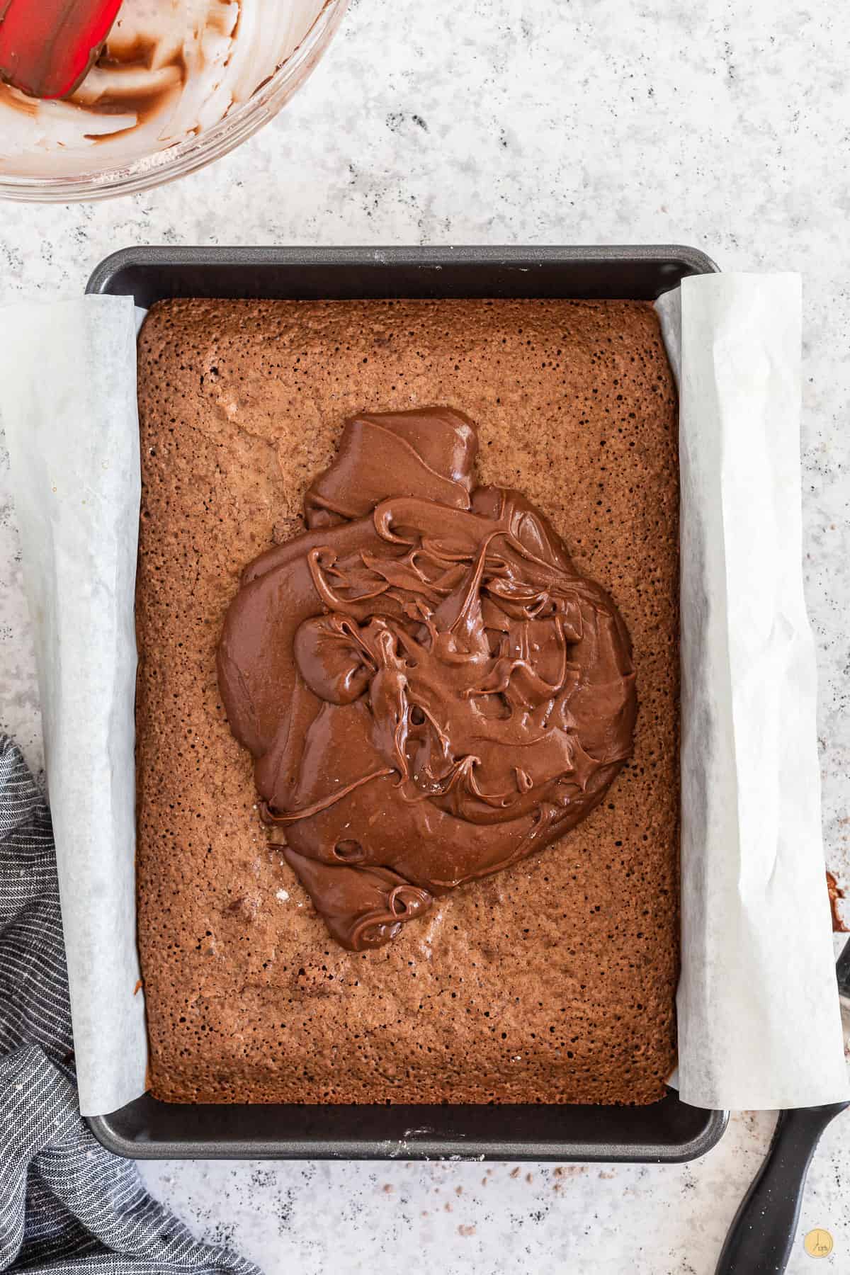 brownies and frosting in a pan