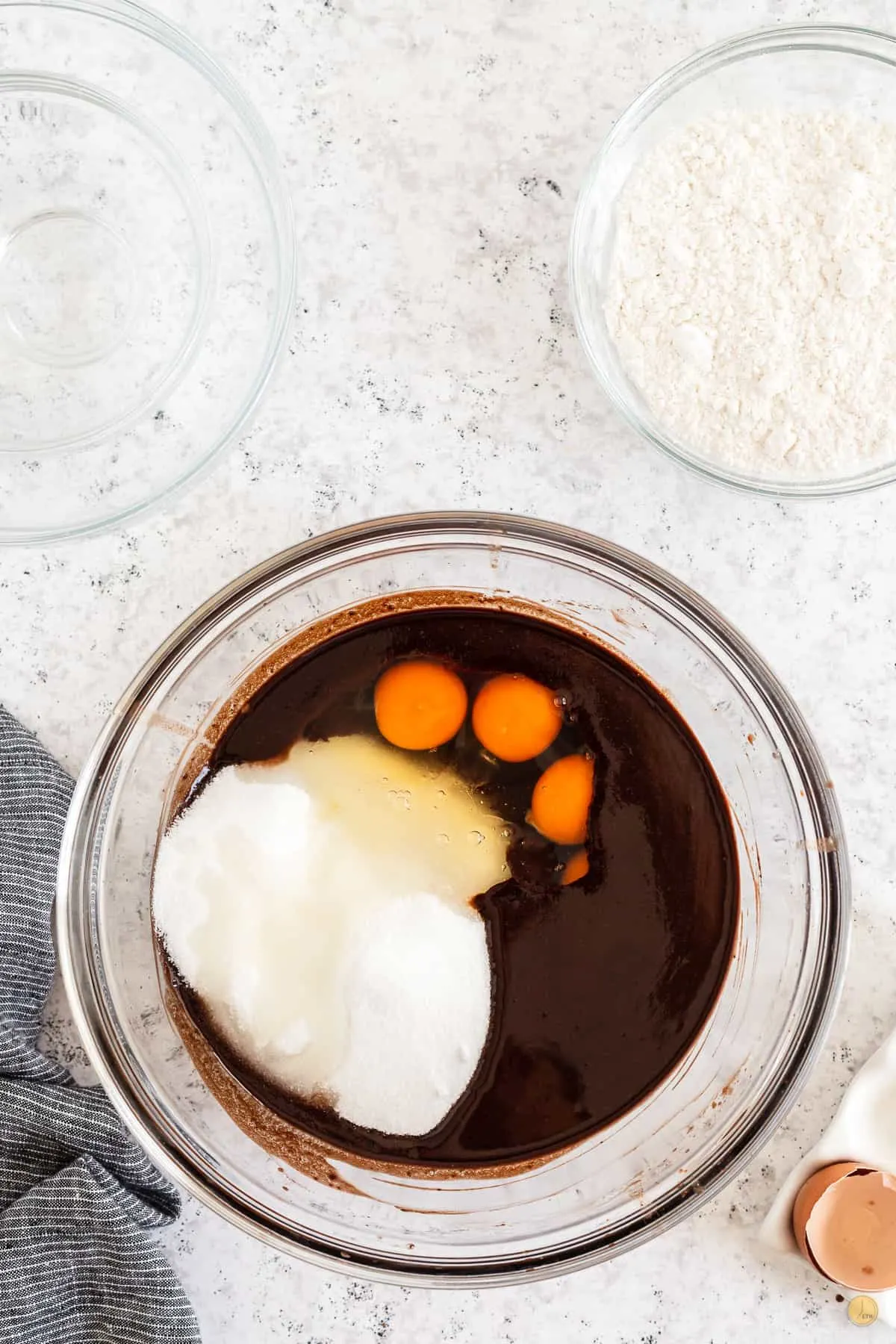 chocolate, eggs, and sugar in a bowl