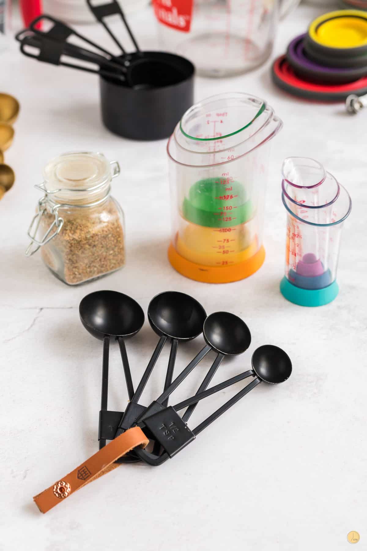 A selection of tablespoons and beaker measuring cups for ounces