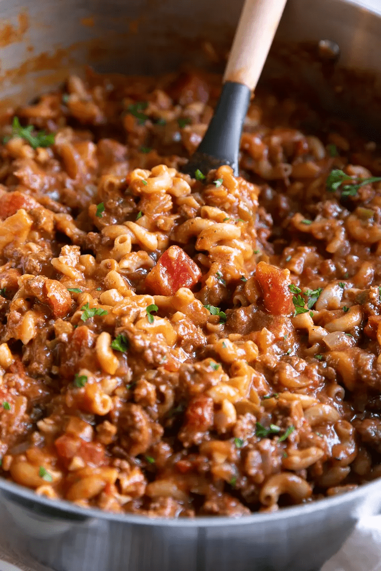 large pot of goulash with a wood spoon