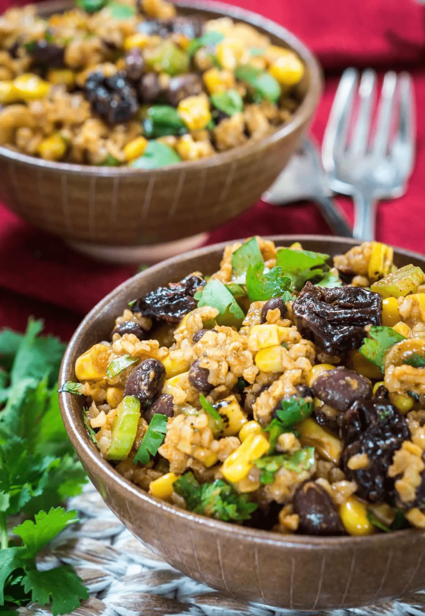 Cherry chipotle salad in a brown bowl on a table.