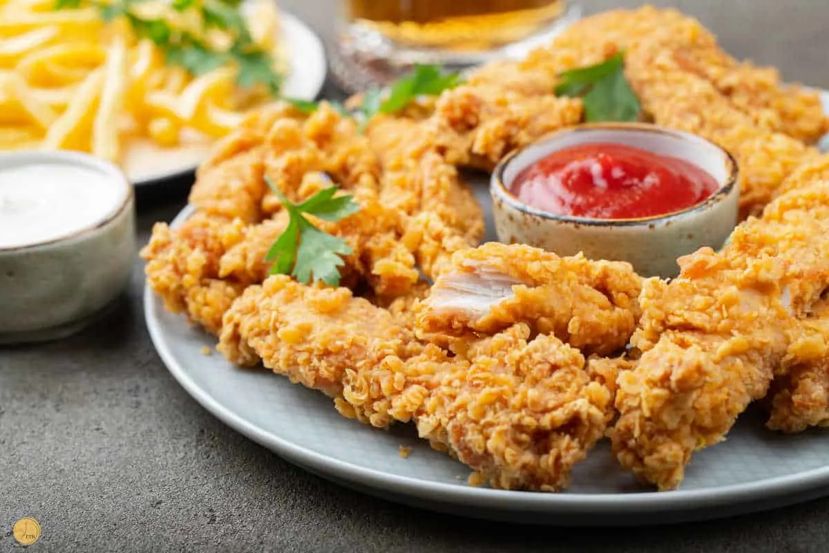 chicken tenders on a plate with ranch