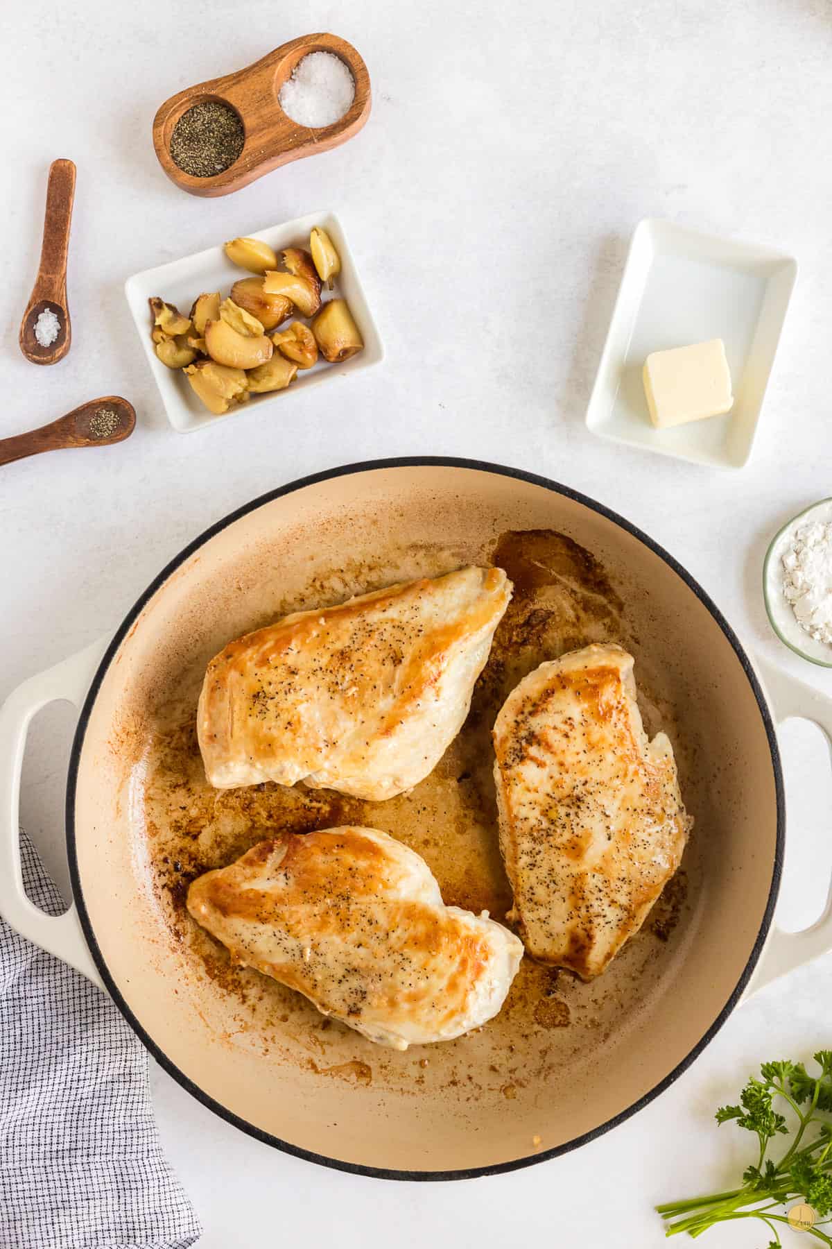 three pieces of cooked chicken in a white pan