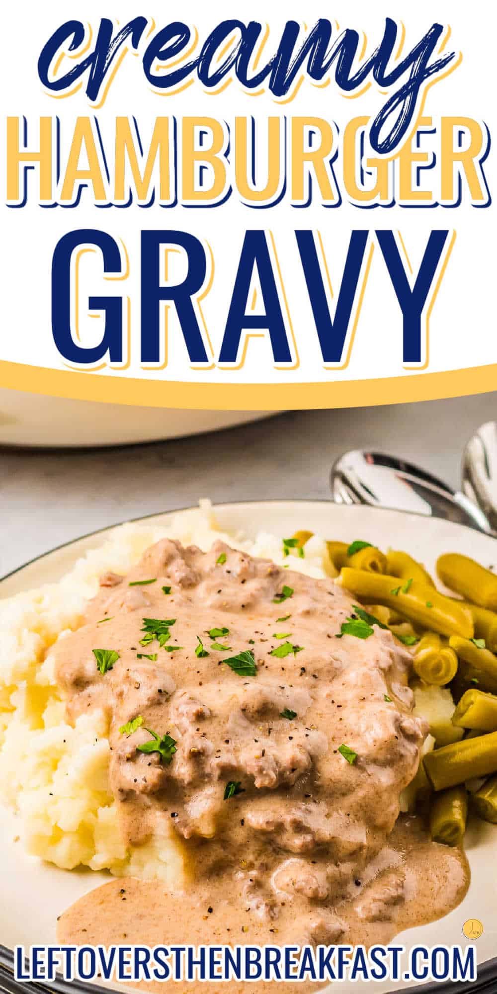 Close up of a white plate with a black rim filled with mashed potatoes topped with sausage gravy with a side of green beans with a text box on top saying "Creamy Hamburger Gravy".