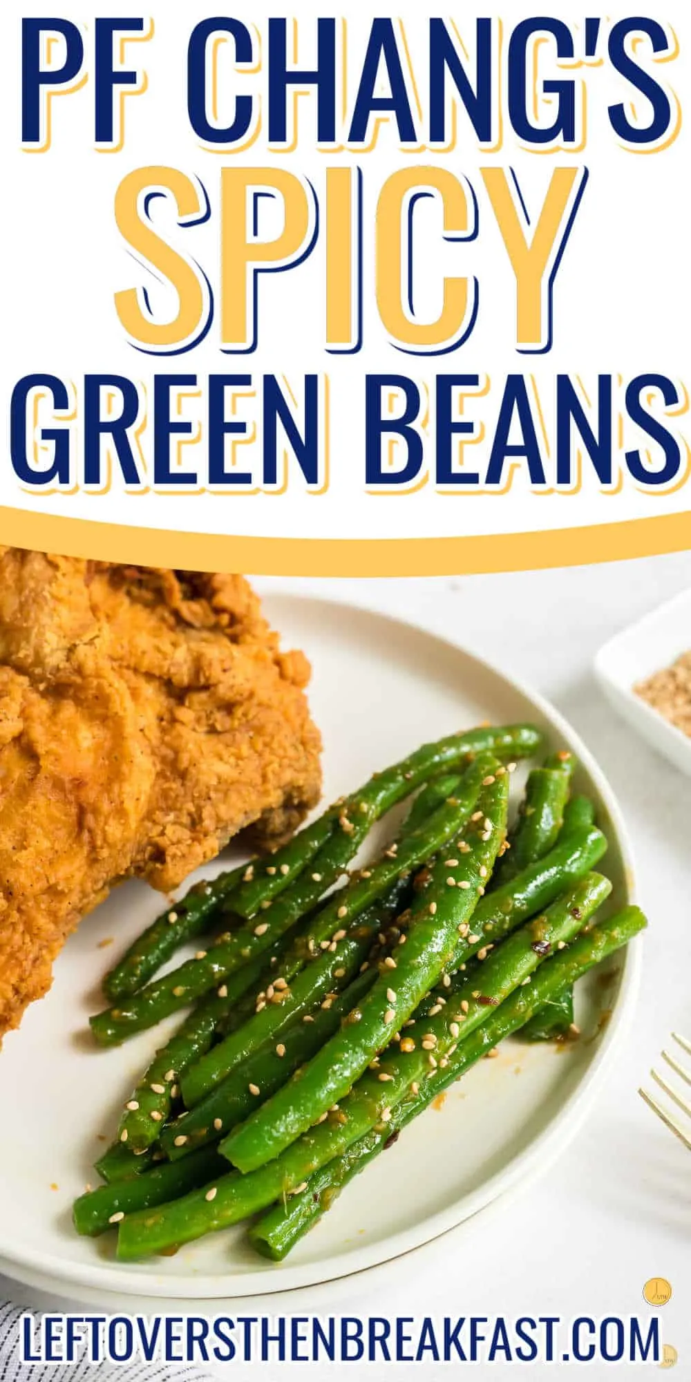 Close-up of an oval plate with fried chicken on one side and spicy green beans on the other side. There is a text box on the top saying "Spicy Green Beans".