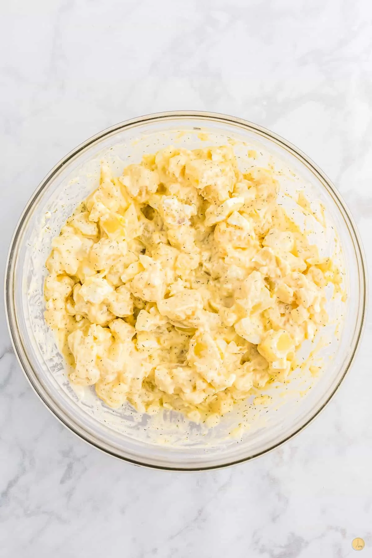 clear bowl of creamy potato salad