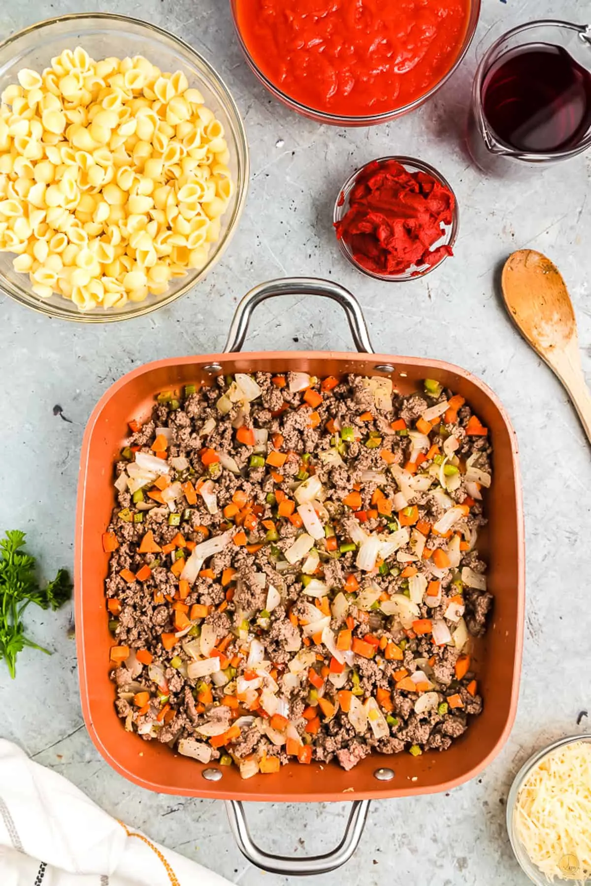 cooked beef and aromatics in a square pan