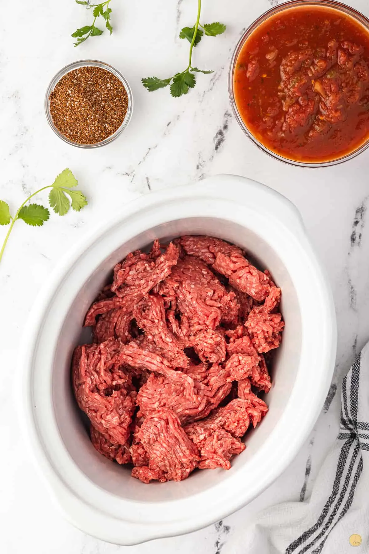 raw ground beef in a slow cooker