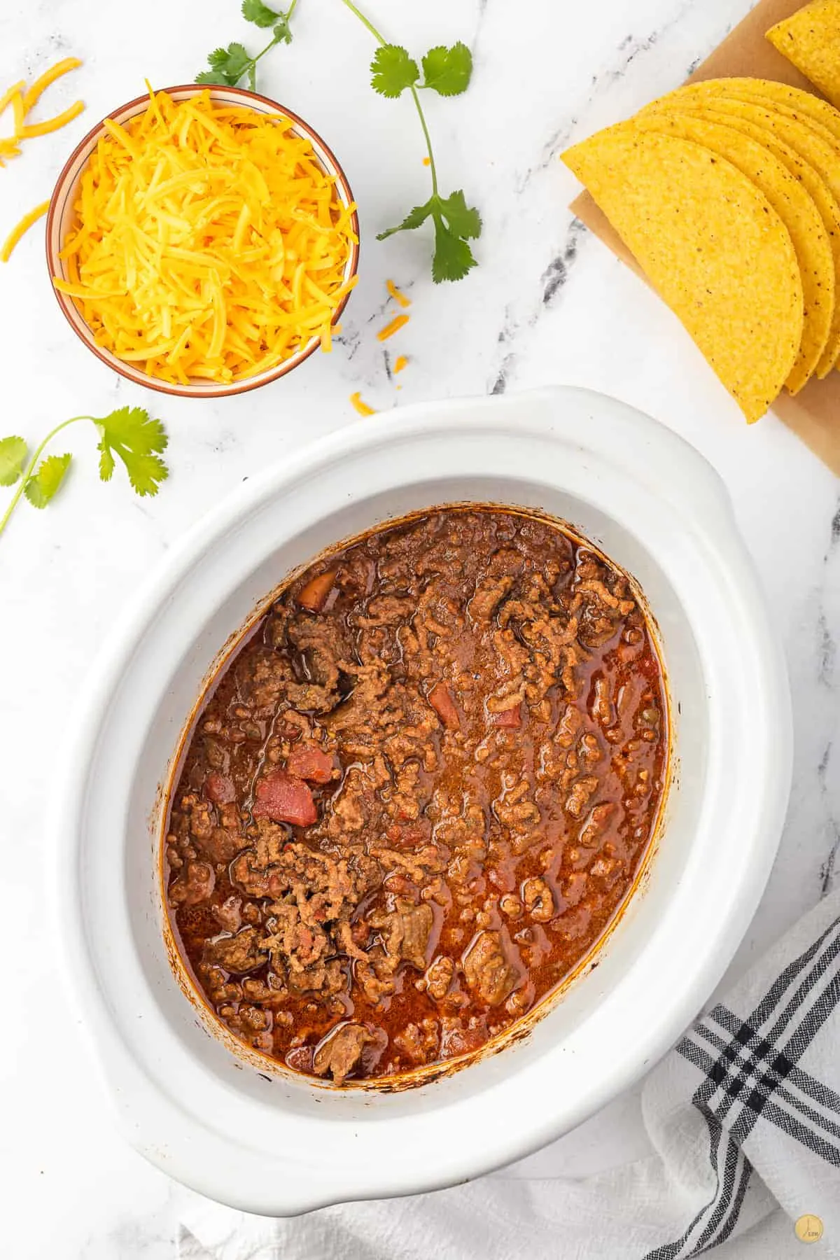 white slow cooker with cheese and ground beef