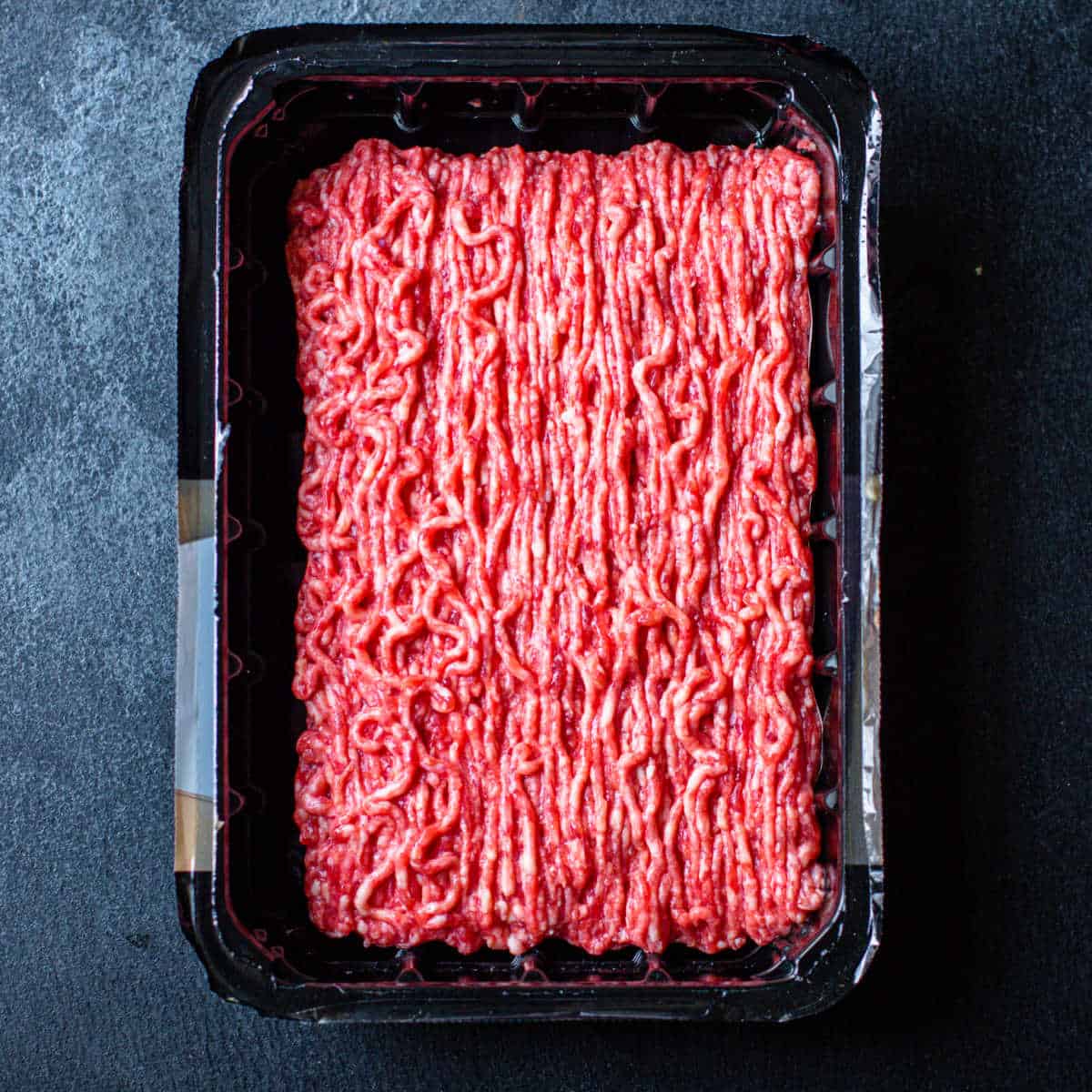 overhead picture of ground turkey in a black package