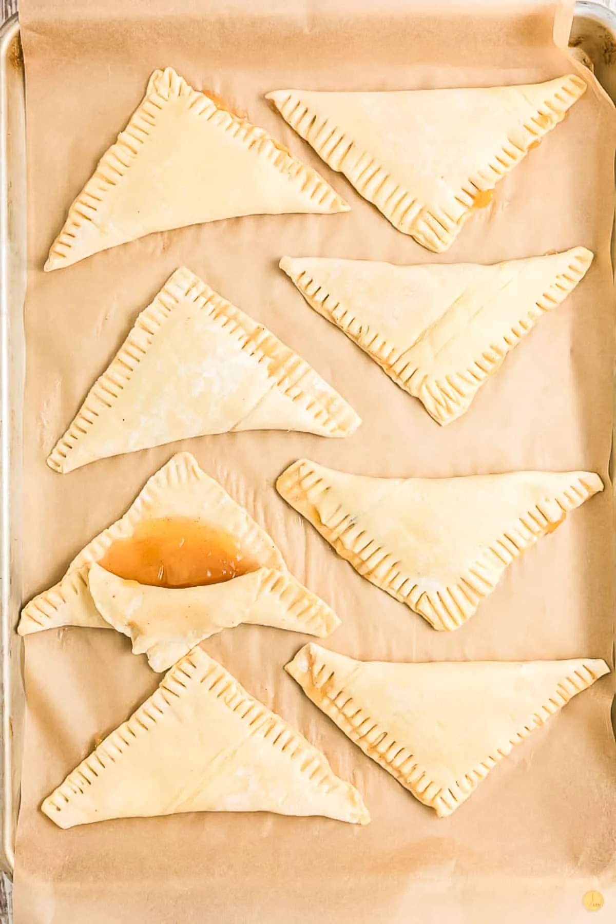 puff pastry triangles on parchment paper