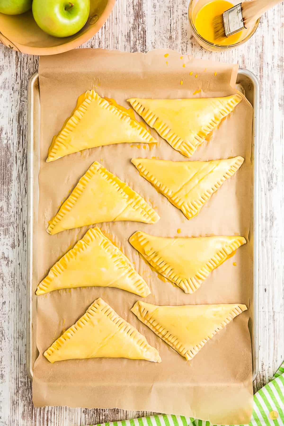 unbaked turnovers on a baking sheet