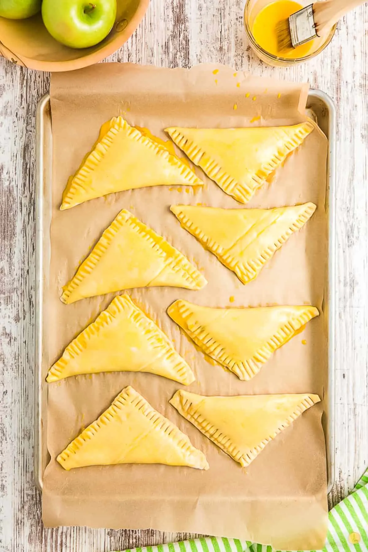 unbaked turnovers on a baking sheet