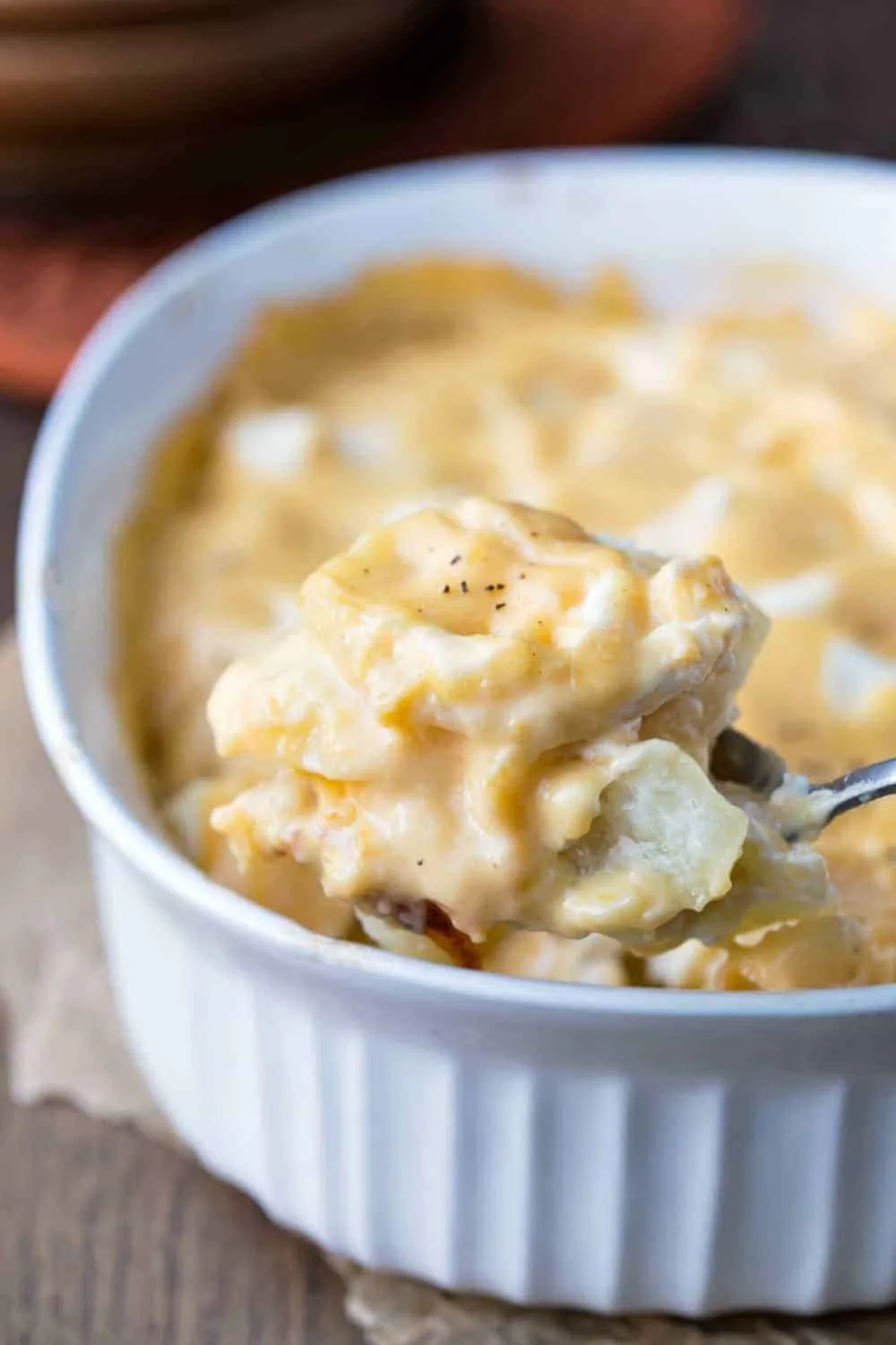 cream cheese scallop potatoes in a casserole dish