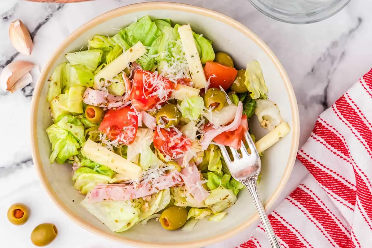 bowl of salad with red and white striped napkin
