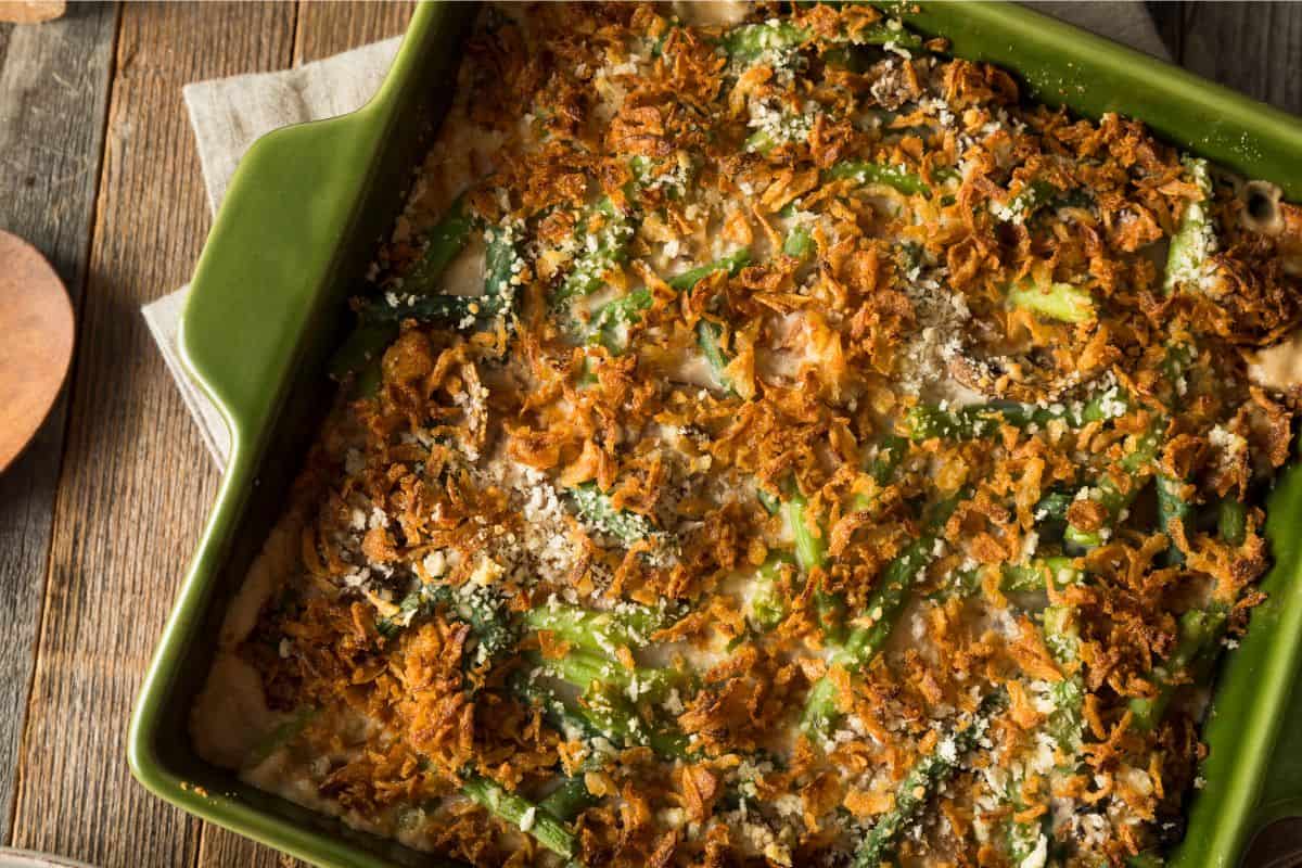 close up of green bean casserole in a green dish