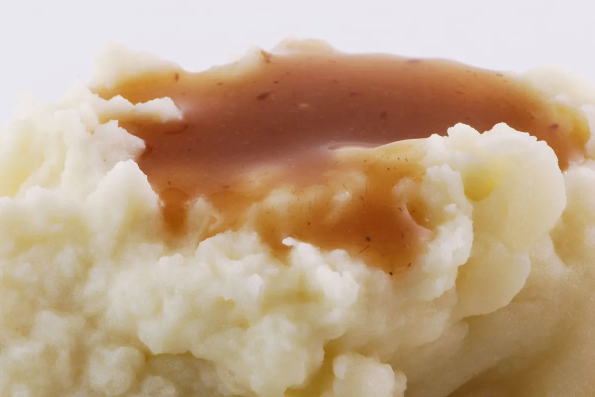 mashed potatoes with gravy on top close up