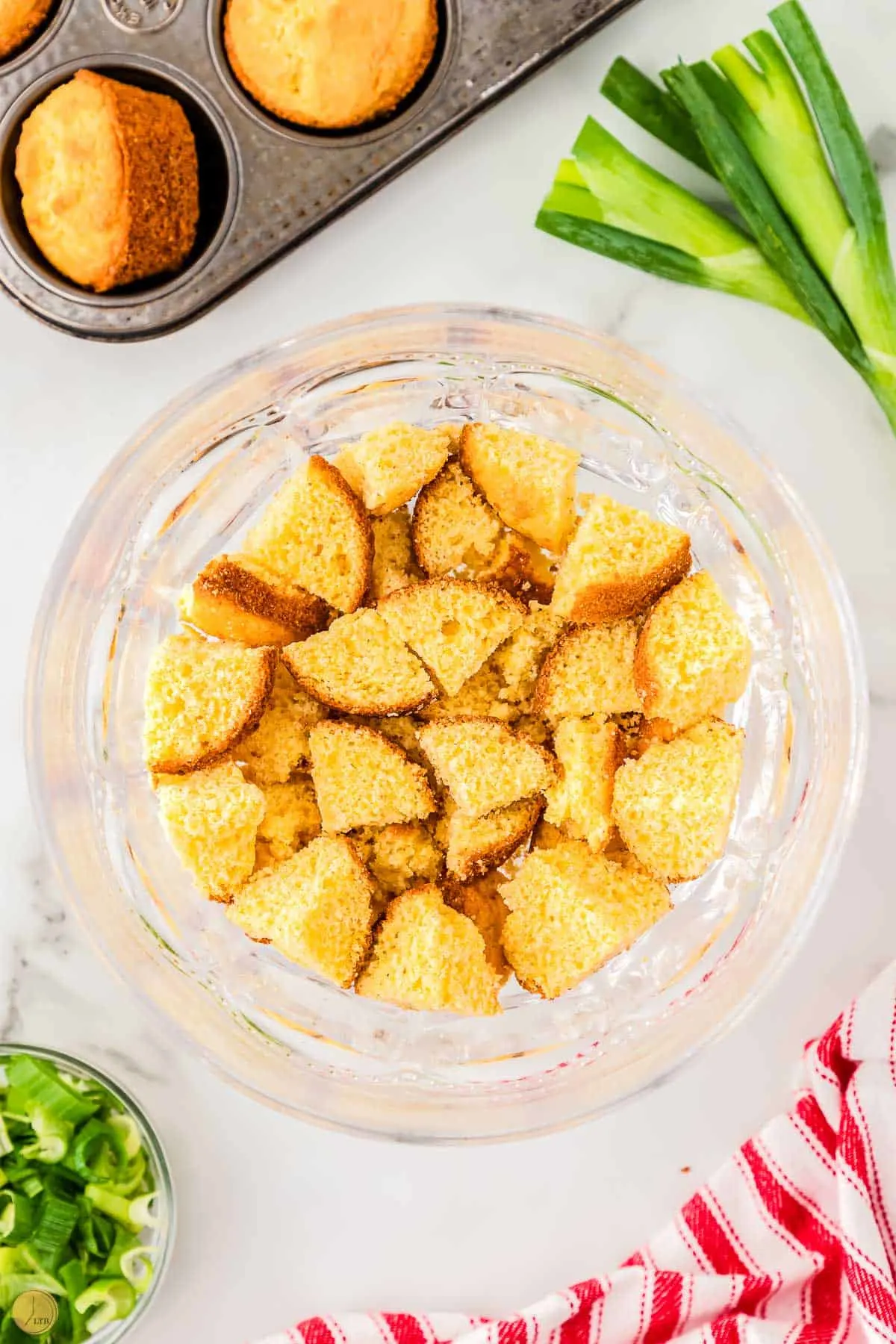 chunks of cornbread in a clear trifle bowl