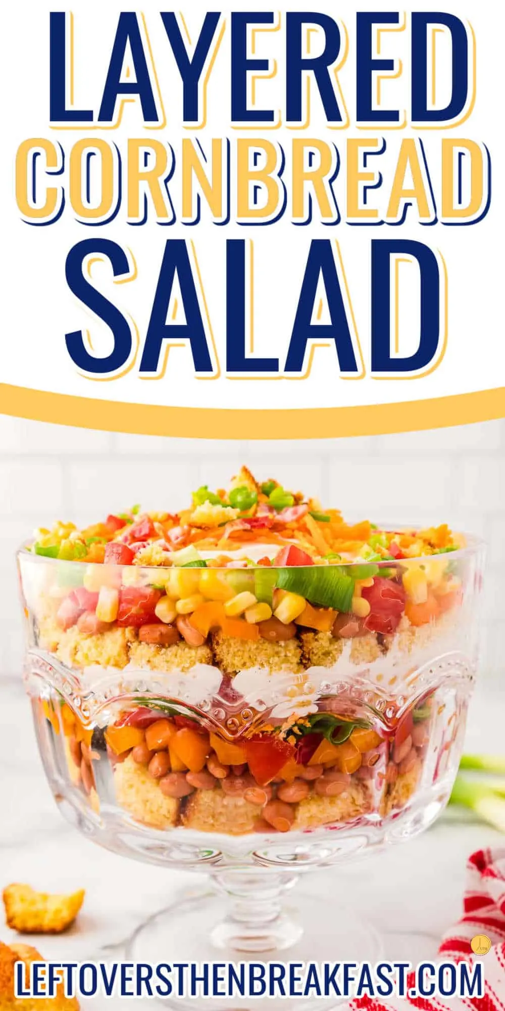 cornbread salad in a clear trifle bowl with banner and text