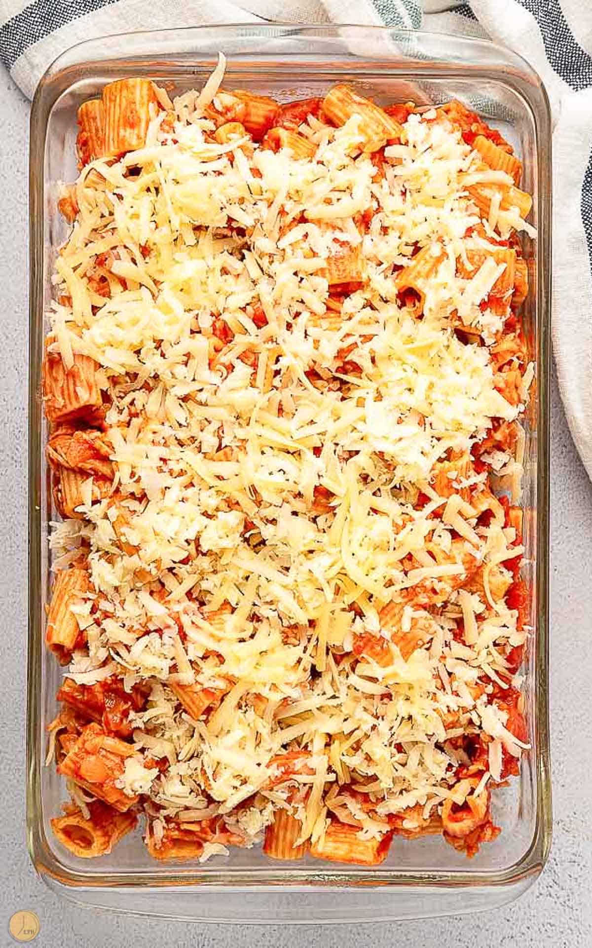 unbaked rigatoni casserole in a clear dish