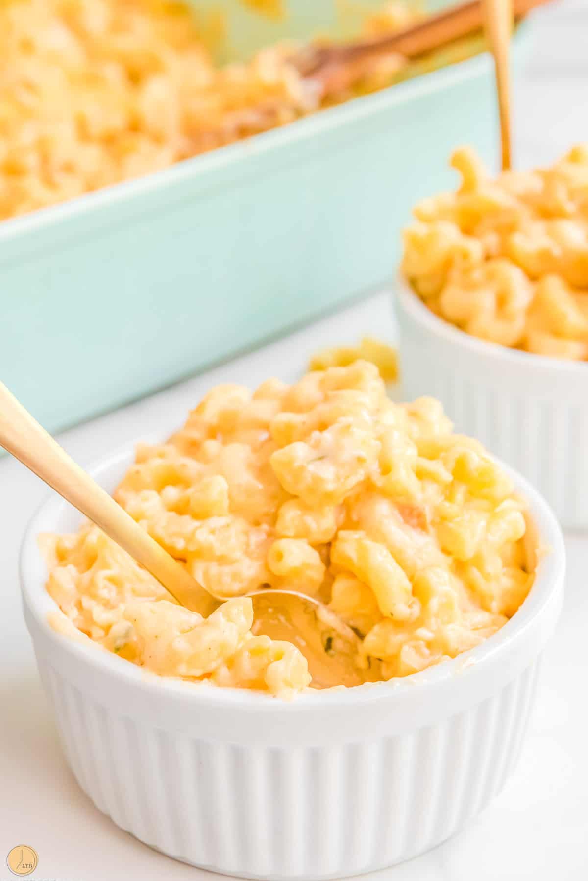 small bowls of mac and cheese with gold forks