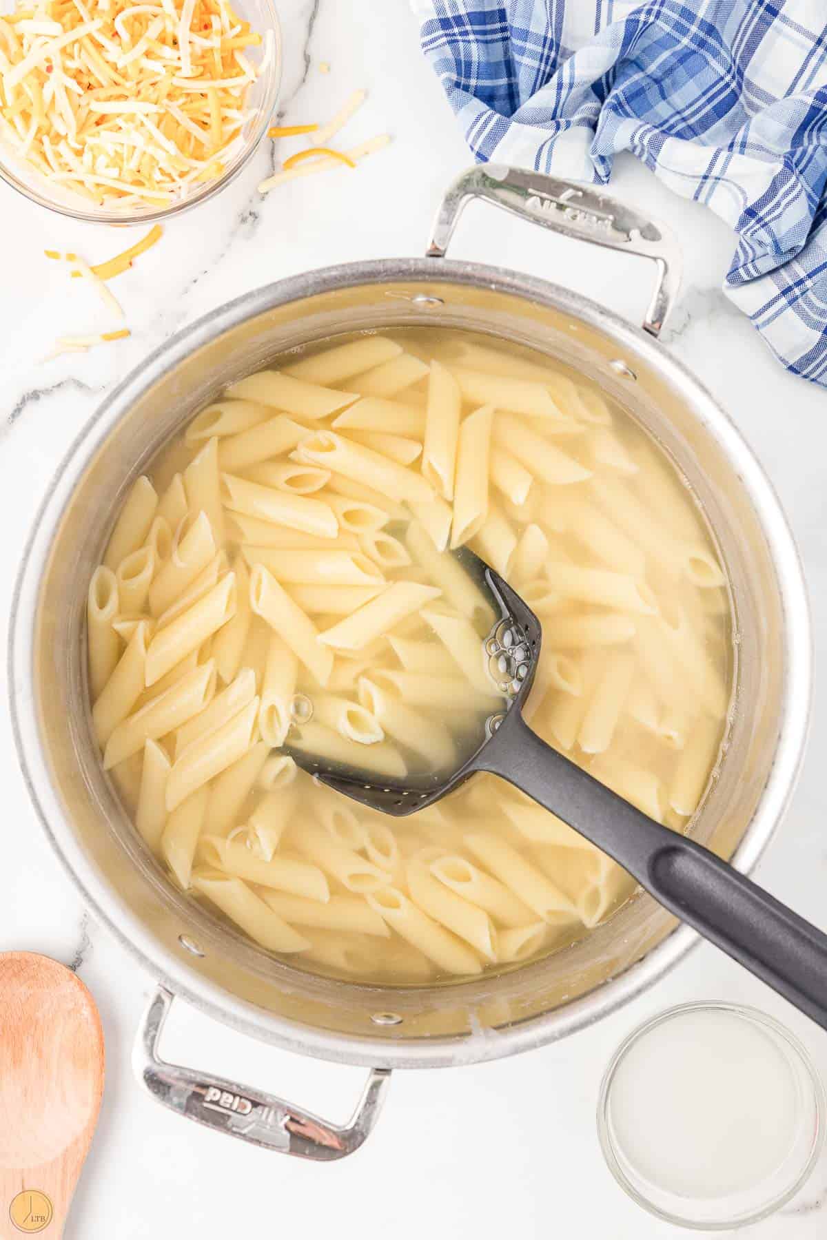 penne pasta cooking in a pot