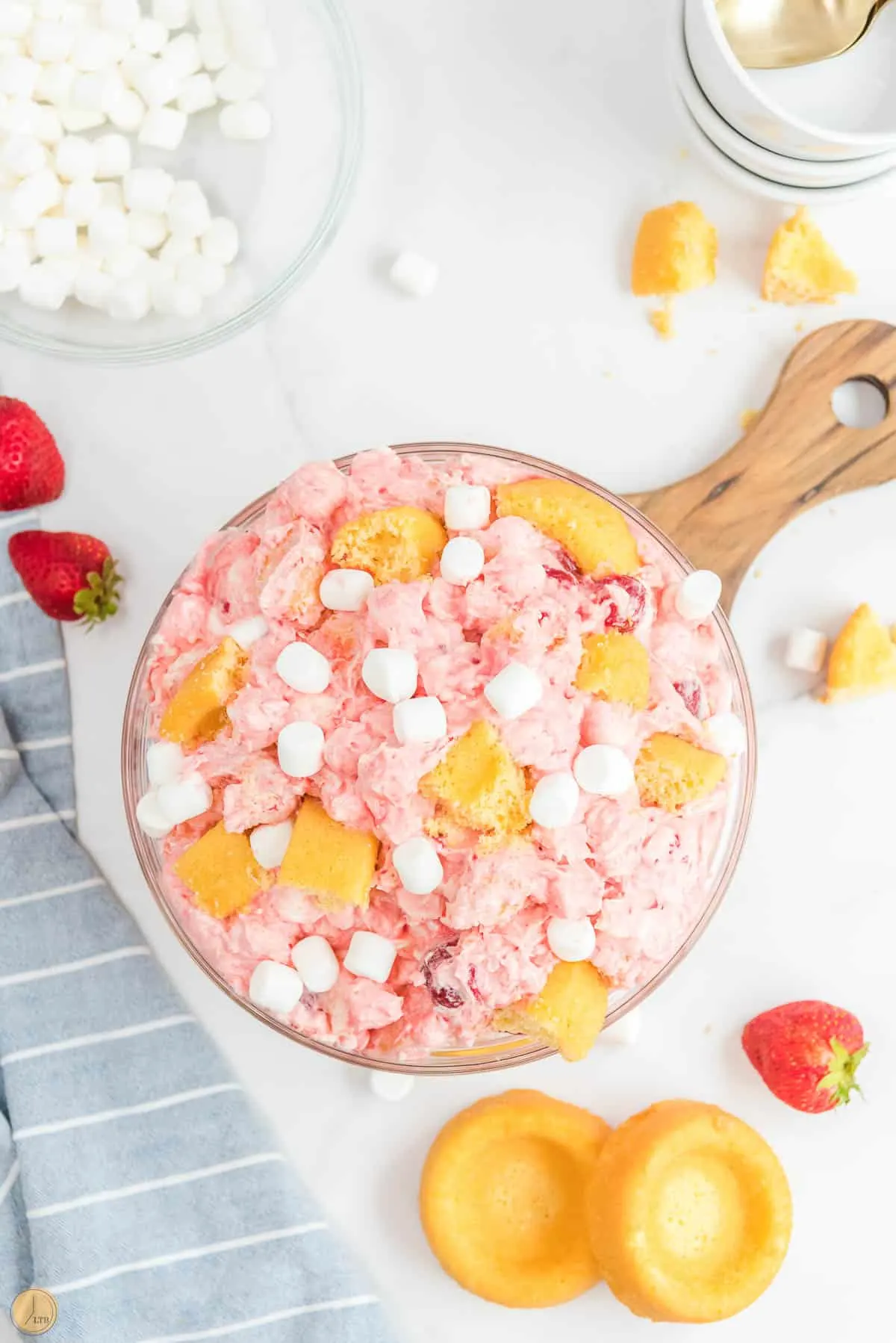 strawberry fluff salad on a wood board with blue napkin