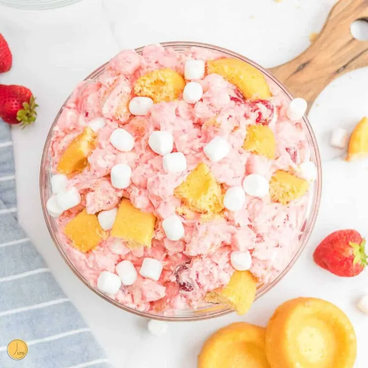 strawberry fluff salad on a wood board with blue napkin