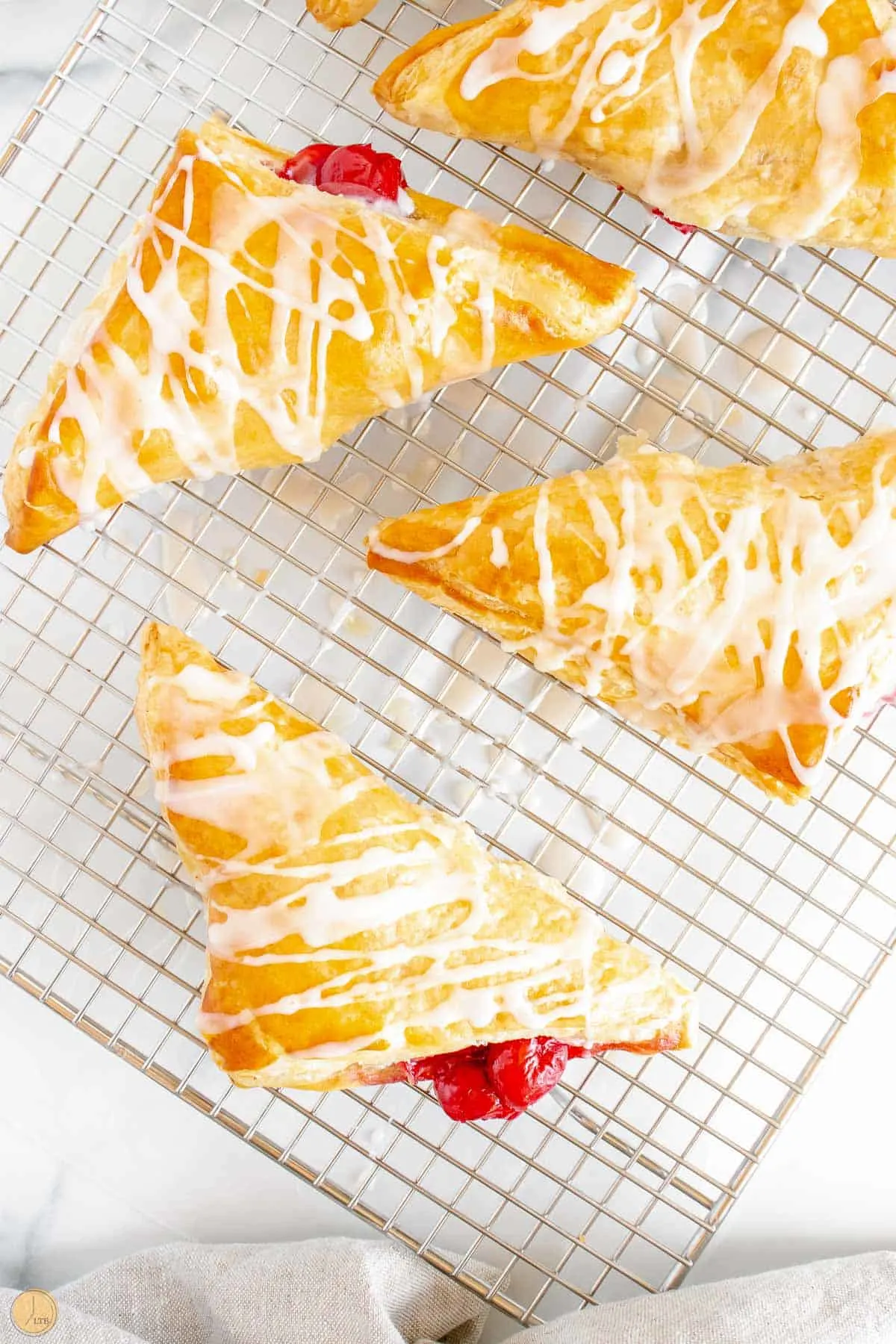 wire cooling rack with cherry turnovers on it
