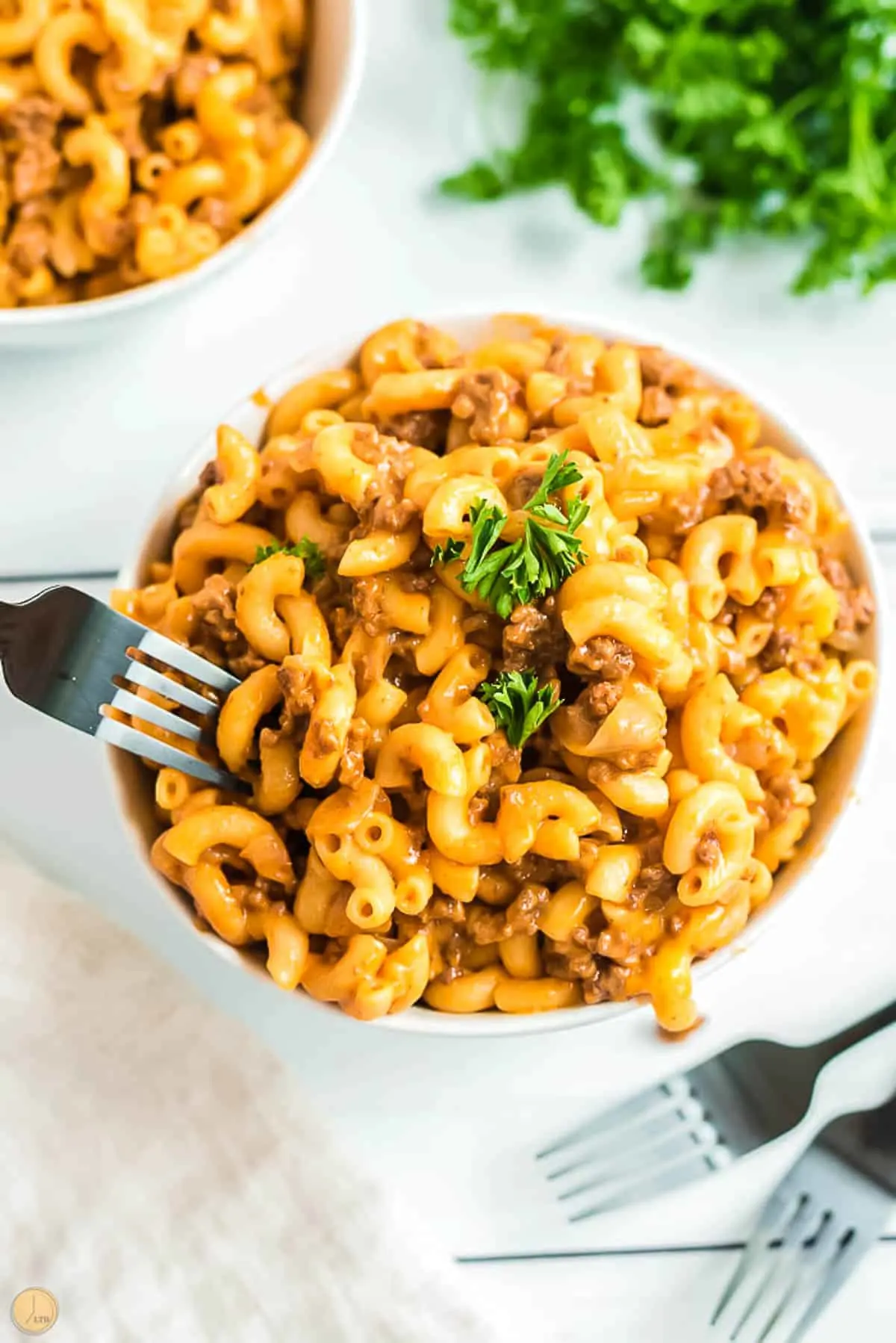 hamburger helper in a bowl with a fork and parsley