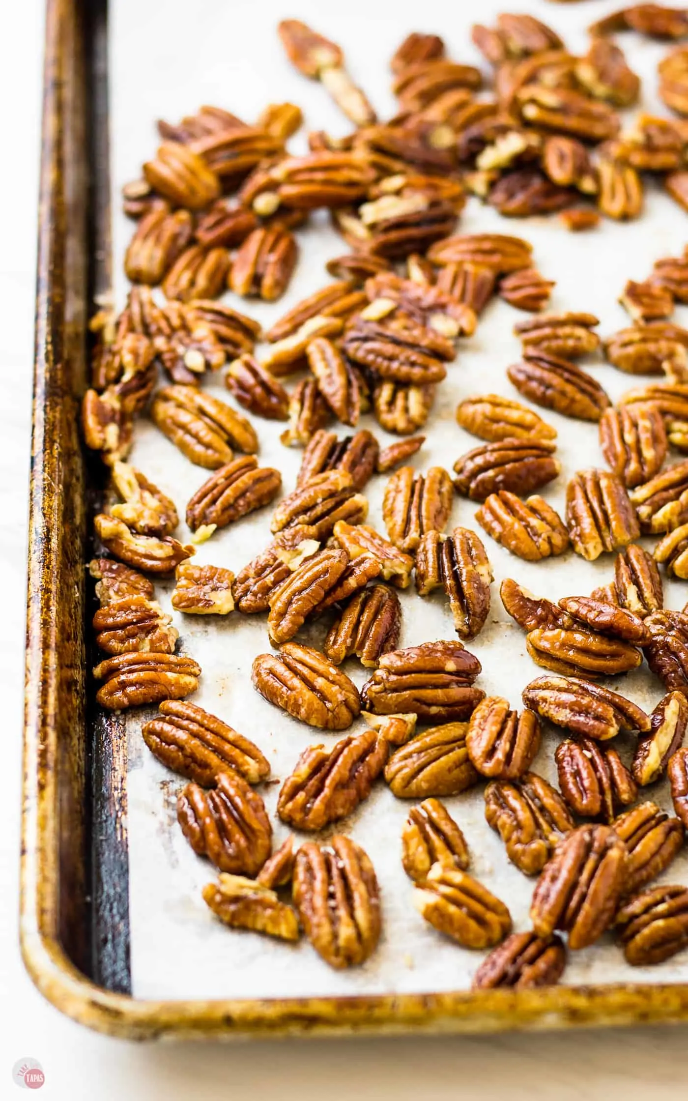 baking sheet with parchment paper and pecan halves